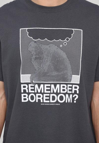 Gray cotton t-shirt featuring a white graphic of a seated figure in thought, with the text "REMEMBER BOREDOM?" in bold white letters.