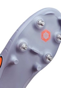 Semelle de chaussure de football à crampons, en plastique gris avec des accents orange, dotée de six crampons transparents et d'un logo "ANTI CLOG" au centre.