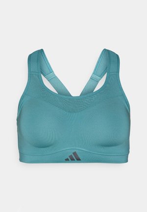 Sutien sport de culoare teal cu o textură netedă, având o bandă lată, bretele încrucișate și un logo Adidas negru în colțul din dreapta jos.