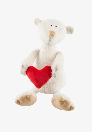 Stuffed polar bear in white fuzzy fabric, with beige patches on feet and a small brown nose, holding a red heart-shaped plush.