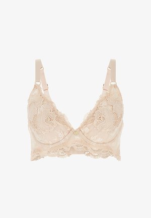 Čipkasti grudnjak svijetle bež boje, s cvjetnim uzorcima, V-izrezom, podesivim trakama i malim gumbom u sredini.