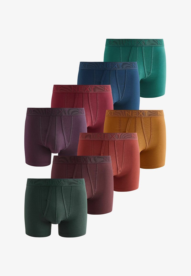 Huit paires de boxers pour hommes dans des nuances de vert, bleu, rouge, violet, moutarde et bordeaux, disposées en rangées décalées.