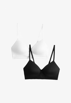 Due bralette wireless con sottili spalline regolabili, una bianca e una nera, esposte una accanto all'altra su uno sfondo semplice.