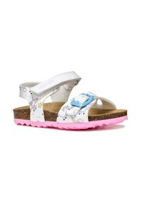 Sandalias blancas con patrón de unicornio y arcoíris, dos correas ajustables, plantilla de corcho y suela de goma rosa con borde en zigzag.