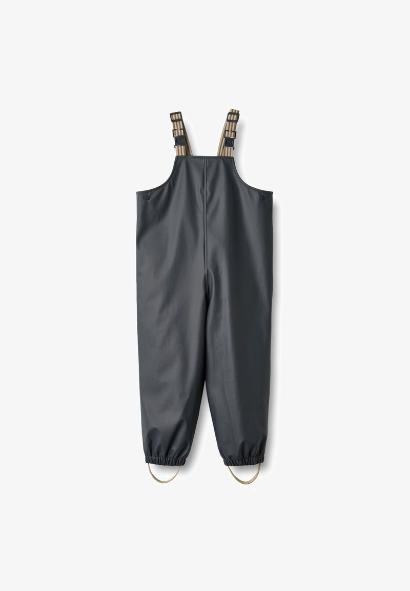 Pantalon à bavette noir imperméable avec bretelles beige réglables et poignets élastiques avec boucles pour les pieds en bas.