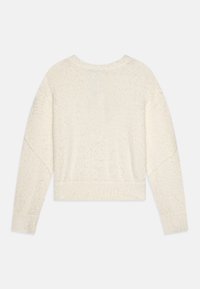 Kremfarget, kort sweatshirt med en strukturert, fuzzy overflate, som har lange ermer og ribbede mansjetter. Ingen synlige mønstre eller logoer.