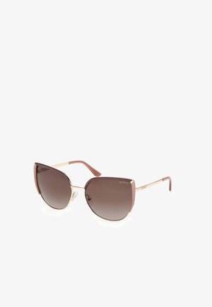 Gafas de sol de estilo cat-eye con lentes marrón degradado, montura de plástico malva y detalles en metal dorado en las varillas. Logo de la marca en el lado derecho.
