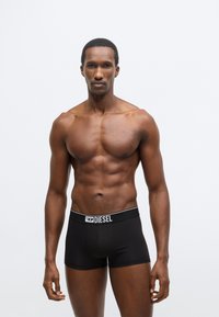 Fekete, rugalmas pamut boxeralsó fehér, márkázott elasztikus derékpánttal. Kényelmes, testre simuló szabással és sima textúrával rendelkezik.