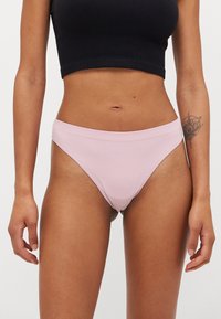 Pink ribbed bikini briefs with a mid-rise waist and minimal coverage. Smooth texture and no visible hardware or patterns.