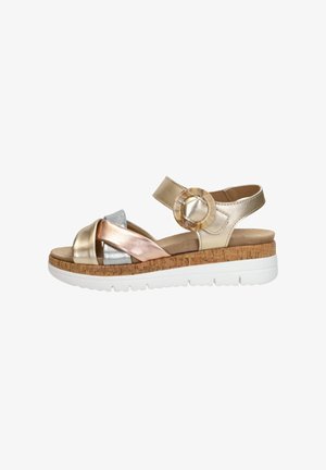 Metallic multi-colored sandal with a cork sole, featuring crossed straps in gold, silver, and rose gold, and a circular accent on the strap.