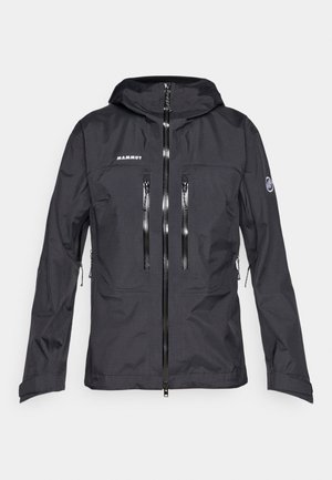 Musta Mammut-takki, jossa on huppu, useita vetoketjullisia taskuja, sileä pinta ja edessä vetoketju. Suunniteltu ulkoilma-aktiviteetteihin.