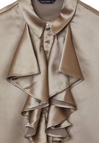 Satin blouse in muted beige with a structured collar, ruffled front detail, and pearl button. Smooth texture with a glossy finish.