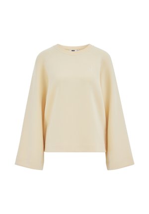 Beżowa bluza z długim rękawem o szerokich rękawach, z okrągłym dekoltem i subtelnym, małym haftowanym logo na górnej lewej stronie klatki piersiowej.