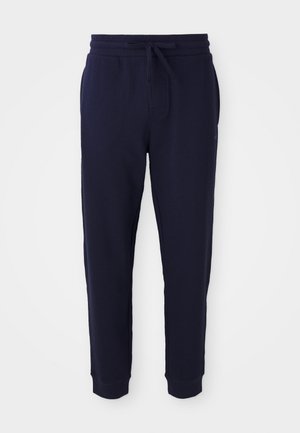 Navy blue collegehousut, jotka on valmistettu teksturoidusta kankaasta; niissä on joustava vyötärö, jossa on naru, resorit nilkoissa ja sivutaskut.
