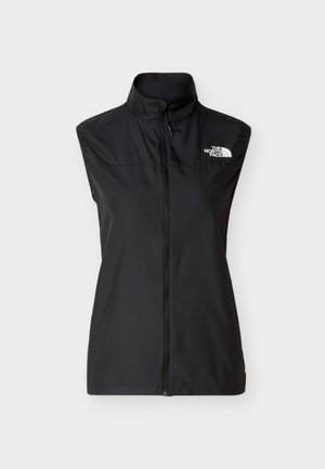 Chaleco negro sin mangas hecho de tela ligera, con cuello alto, cremallera frontal y un logo blanco en el lado superior izquierdo.