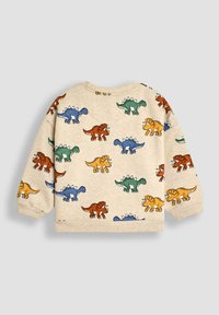 Sweatshirt en tissu beige avec un imprimé de dinosaure. Présente des dinosaures colorés en vert, bleu, orange et jaune, avec un col rond.