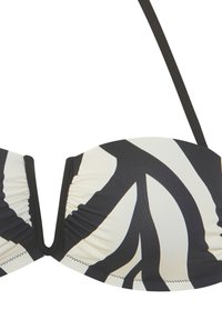 Bikini top s zebra vzorom v čierno-bielej farbe, s vypchávkami, zhromaždenými stranami a jedným nastaviteľným popruhom na jednej strane. Hladká textúra látky.
