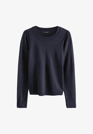 Tummansininen neulepaita, joka on valmistettu pehmeästä kankaasta. Mallissa on pyöreä pääntie, pitkät hihat sekä ribbaus hihansuissa ja helmassa. Paitaa koristaa hieman rypytetty olkapään yksityiskohta.