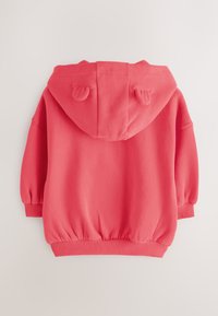 Koralkoralfarvet hættetrøje med rundet kant, elastiske manchetter og ører på hætten. Blødt materiale, afslappet pasform.