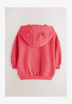 Korallinpunainen hupullinen collegepaita, jossa pyöristetty helma, joustavat hihansuut ja korvat hupussa. Pehmeä materiaali, rento istuvuus.