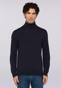 Maglione a collo alto blu navy con maniche lunghe, realizzato in tessuto a maglia, con un logo ricamato discreto sul petto.