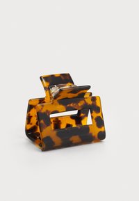 Tortoiseshell hair clip made of plastic with a geometric design. Features a central rectangular opening and polished surface.