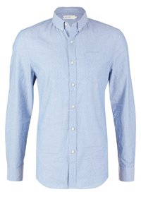 Vaaleansininen pitkähihainen paita, jossa on nappikaulus, rintatasku ja hienovarainen valkoinen pilkkukuvio. Puuvillakangasta, klassinen istuvuus.