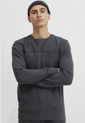Dark gray long-sleeve sweatshirt featuring a contrasting upper panel and pocket, crafted from soft fabric with a smooth texture.