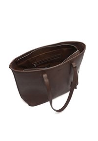 Pruun nahast kandekott, sileda tekstuuri ja tugeva õlarihmaga. Omab tõmblukuga kinnitust ja sisemist taskut korralduseks.