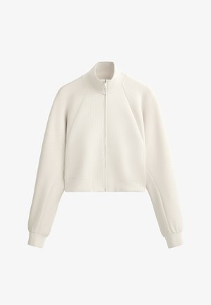 Giacca bianca accorciata con zip realizzata in tessuto a costine, con collo alto e maniche raglan, caratterizzata da una superficie liscia e tasche laterali.