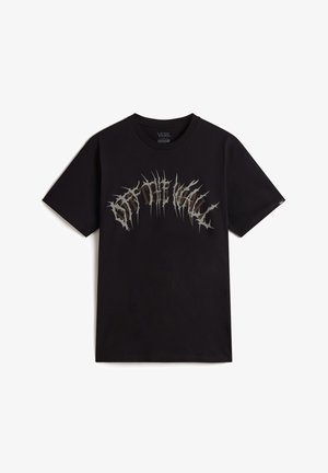 T-shirt en coton noir avec un imprimé graphique texturé en argent "Off The Wall" avec des accents déchiquetés sur la poitrine. Manches courtes, col rond.