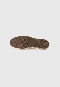Dark brown rubber shoe sole with a textured pattern, featuring a geometric design and a light beige edge.
