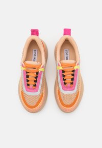 Laced sneakers with a woven texture in tan, orange, pink, and purple. Features a rubber sole and a pull tab at the heel.