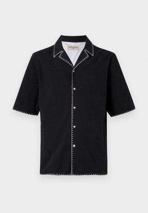 Black short-sleeve shirt with a collar, featuring white contrast stitching along the edges and buttons down the front. Textured fabric.