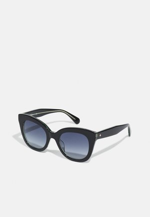 Black cat-eye sunglasses with gradient dark lenses, thick black plastic frame, and subtle green accents on the inside of the arms.