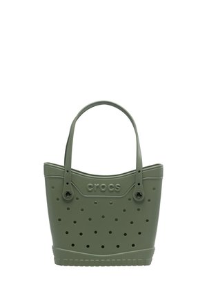 Torba na ramię typu tote Crocs oliwkowa, z perforowanymi otworami, dwoma paskami na ramię i wytłoczonym logo Crocs z przodu.