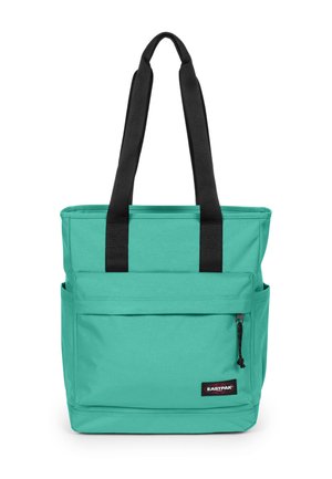 Turkusowa torba typu tote z czarnymi paskami na ramiona, przednią kieszenią na zamek błyskawiczny oraz bocznymi kieszeniami, stojąca pionowo na białym tle.