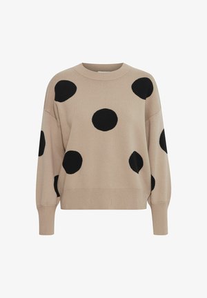 Pull en maille beige avec de grands pois noirs, col rond et manches à coupe ample, présentant des poignets et un ourlet côtelés.