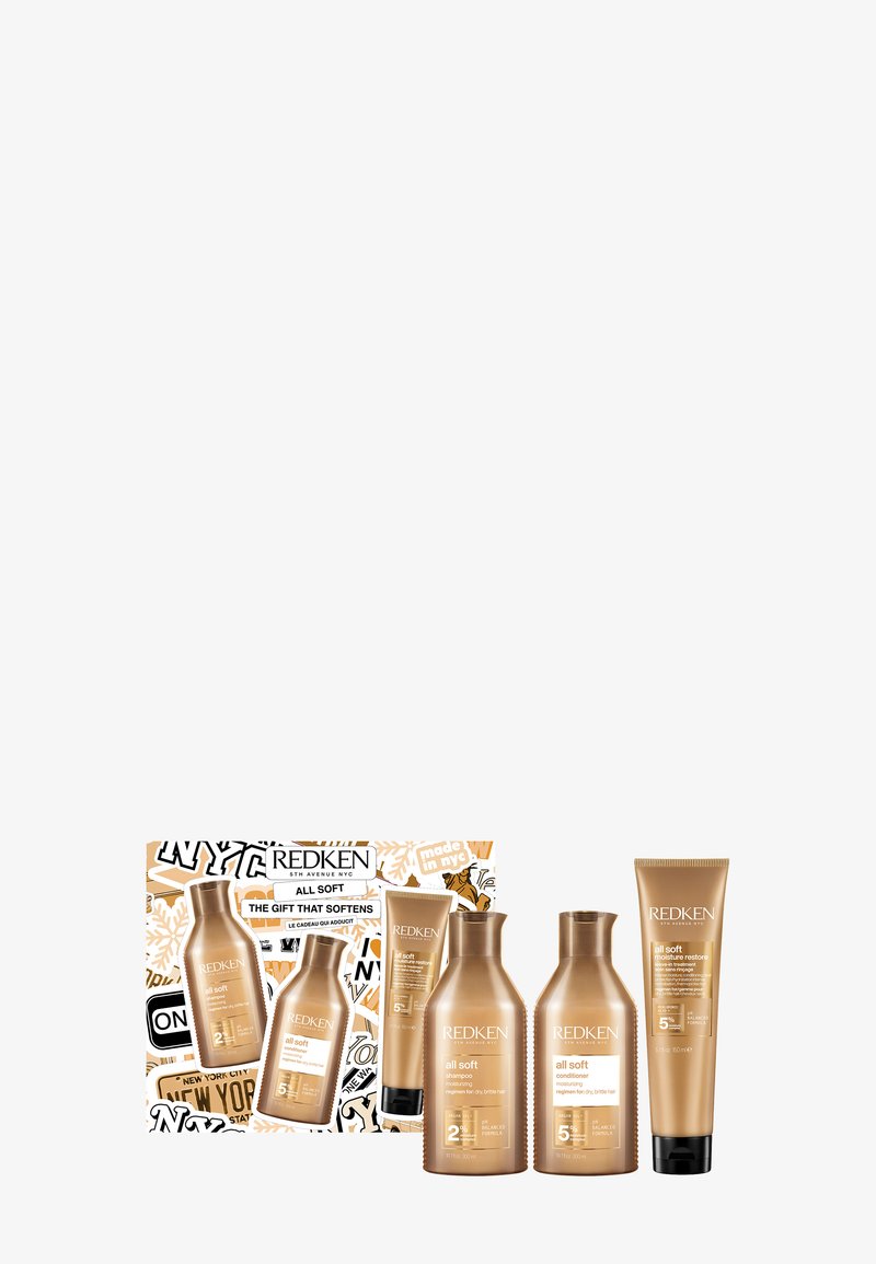 Zestaw prezentowy Redken All Soft zawierający cztery produkty: dwie złote butelki szamponu i odżywki, jedną tubkę kremu oraz stylowe opakowanie z grafiką przedstawiającą Nowy Jork.