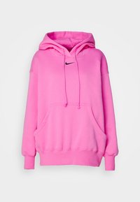 Vaaleanpunainen huppari, joka on valmistettu pehmeästä kankaasta. Hupussa on kengurupocket, narut ja musta Nike-logo rintakehässä.