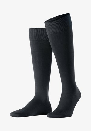Ciorapi negri până la genunchi cu manșete ribbate, realizați dintr-un material neted și elastic. Dispune de toc și vârf întărit.