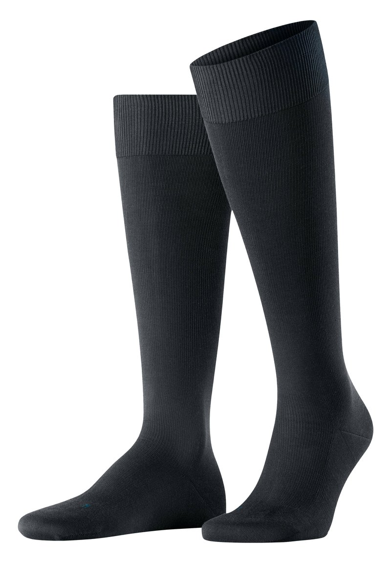 Calze nere fino al ginocchio con risvolti a costine, realizzate in un materiale liscio ed elastico. Presentano un tallone e una punta rinforzati.