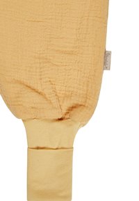 Gelbes Musselin-Gewebe mit strukturiertem Finish; verfügt über einen weichen, elastischen Saum am Fuß und ein kleines Markenlabel an der Seite.