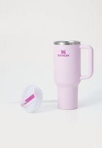 Pink stainless steel travel mug with a handle, featuring a silver rim and logo. Includes a white lid and straw for easy sipping.