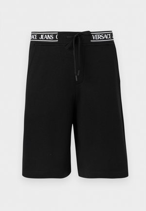 Μαύρο σορτς μέχρι το γόνατο με πλαϊνές τσέπες και ζωνάκι με κορδόνι μέσης, με λευκή επιγραφή "VERSACE JEANS".