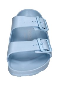 Light blue faux leather sandal with two adjustable straps, square buckles, textured footbed, and a contoured ergonomically designed sole.