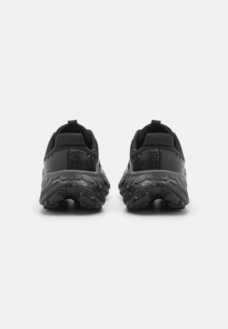 Zapatos deportivos negros con una parte superior de malla texturizada, talón reforzado y una suela gruesa y con patrón para una mejor tracción y soporte.