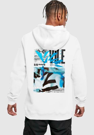 White hoodie featuring a vibrant blue graphic and black text on the back. The design includes abstract shapes and patterns, with notable print details.