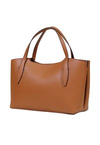 Sac à main en cuir marron avec deux poignées et une surface texturée lisse, présenté sur un fond blanc.