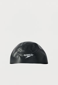Black silicone swim cap with a smooth, glossy texture, featuring a white Speedo logo on the front. Rounded shape, designed for water resistance.